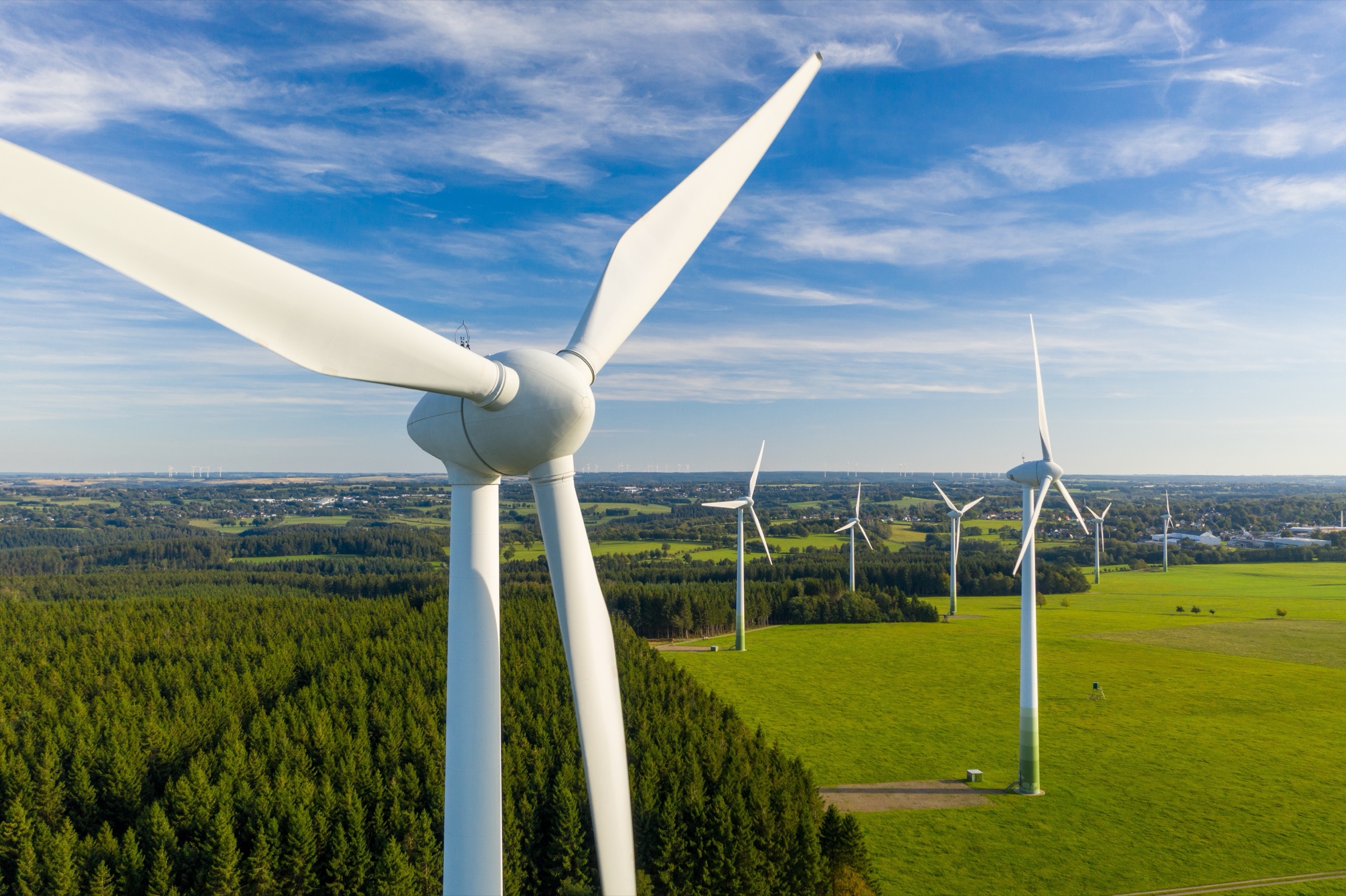 Wind turbine generators across open farmland in the southern Tamil Nadu wind corridor