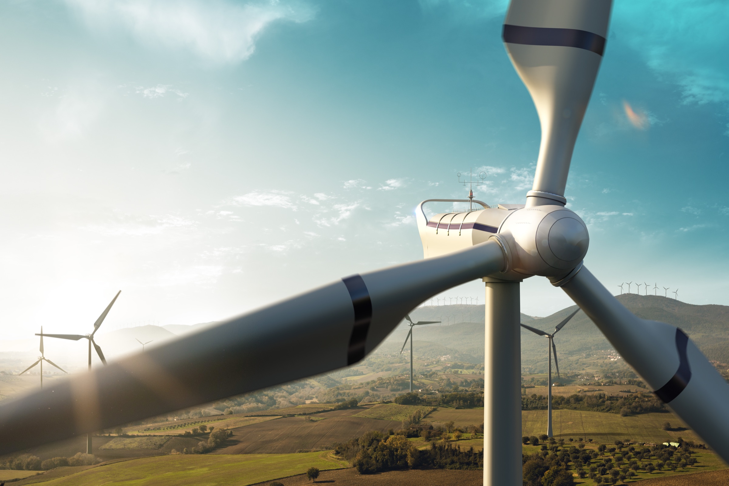 Wind turbine rotor turning above open country near the Tenkasi cluster